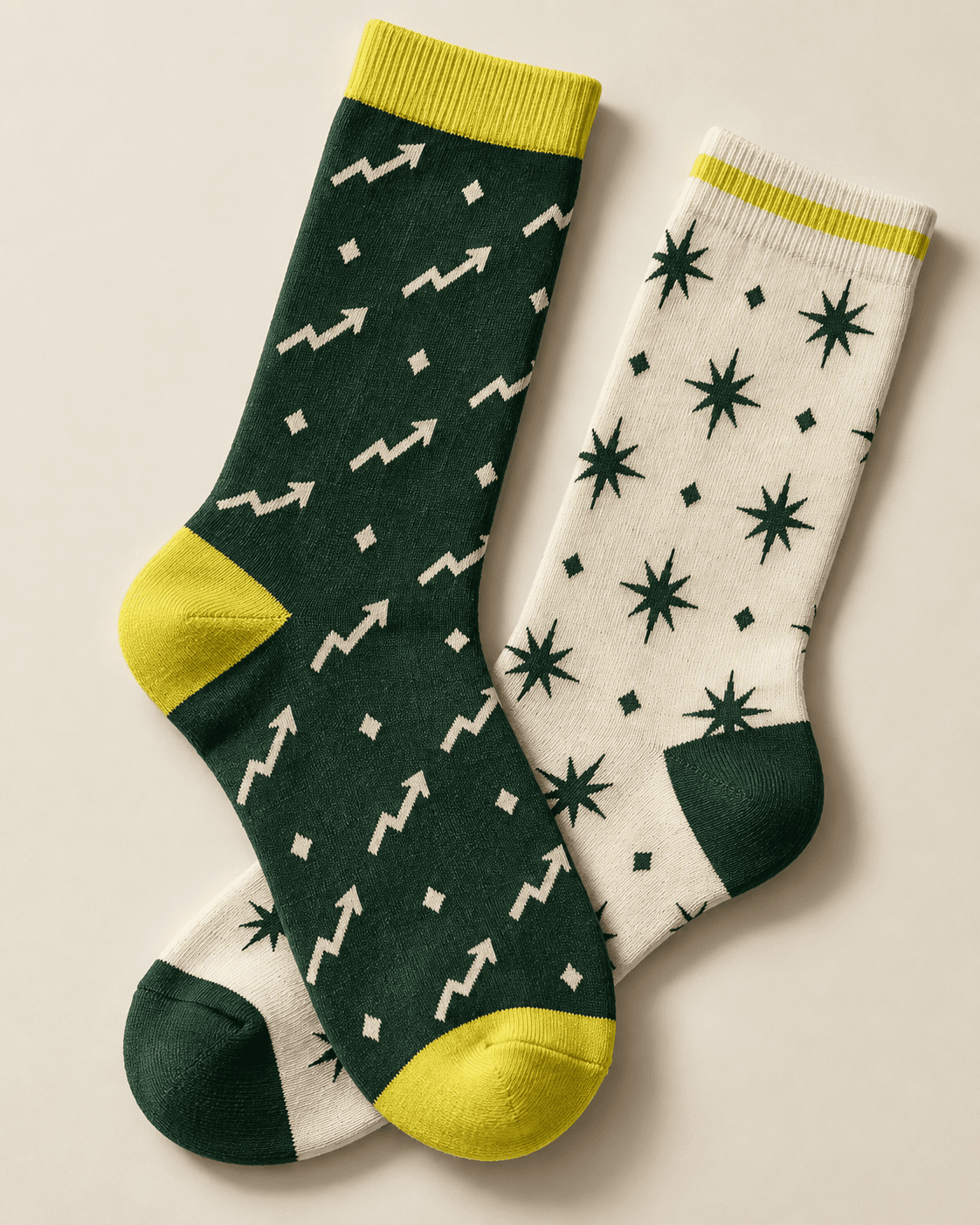 Illustrative green and cream knitted socks with chart arrows and geometric motifs